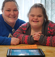 A Teacher and Student sitting together at their desk